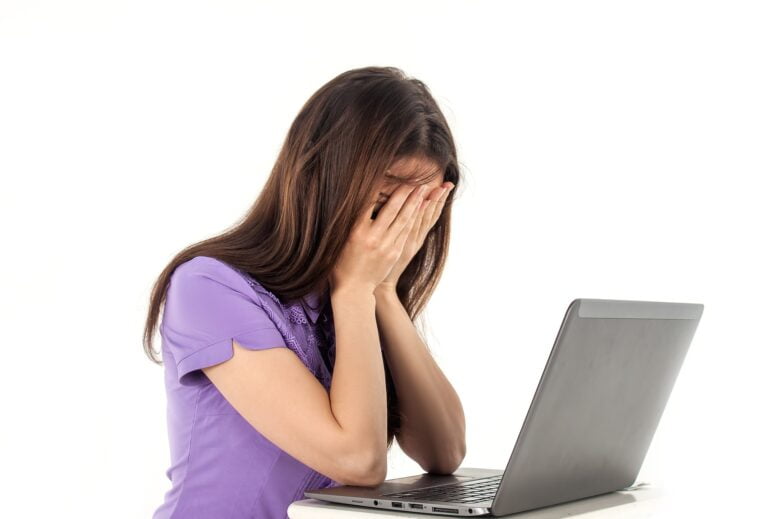 Young woman tired of working hard in laptop