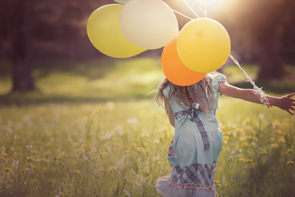 Girl with Balloons on Field