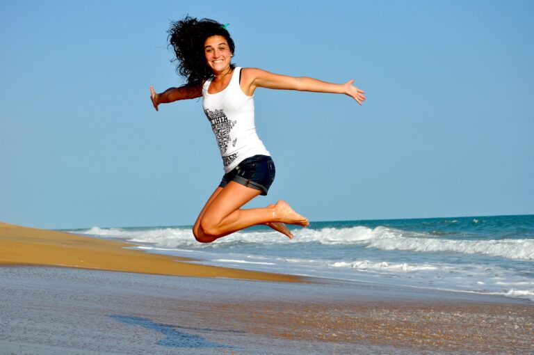 Happy woman jumping in beach