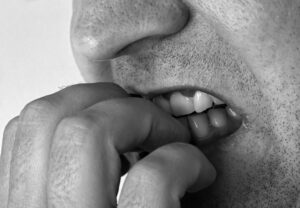 Man biting nails