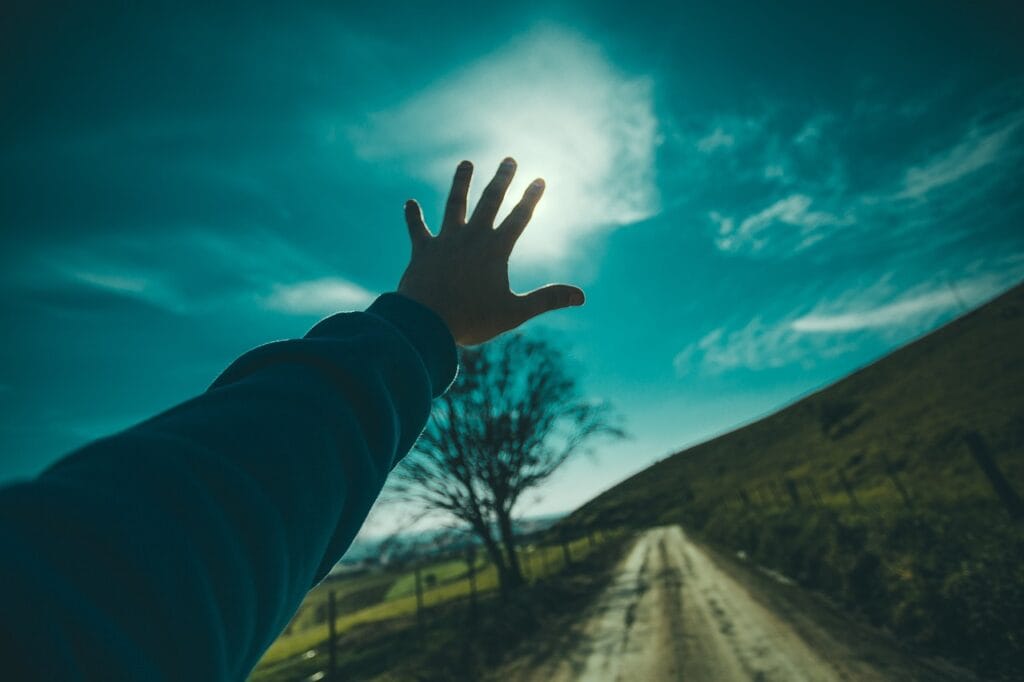 Hands reaching out to sky