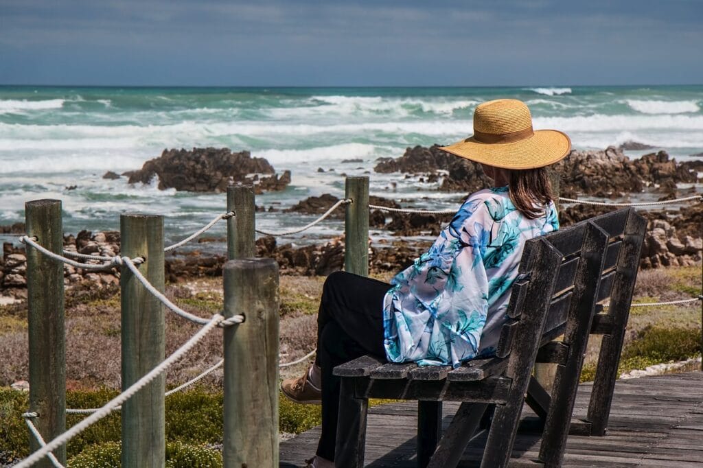 Woman, sitting in beach and pondering