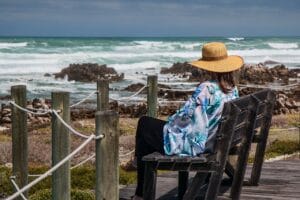 Woman, sitting in beach and pondering