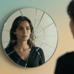 Woman looking at cracked mirror reflection representing imposter syndrome recovery journey